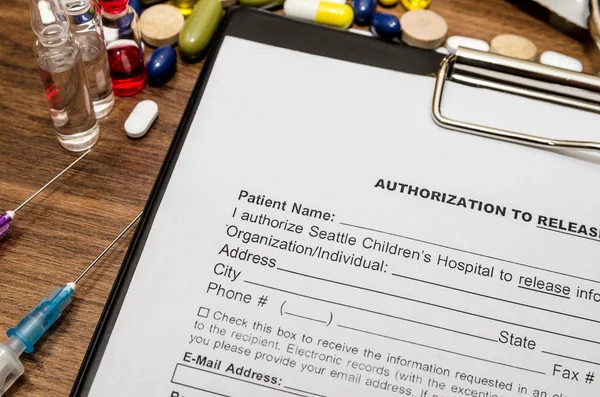 blank patient information with stethoscope, syringe and pills