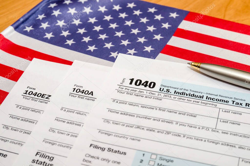 1040 tax form with pen and american flag