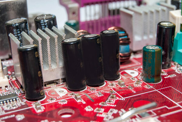red computer motherboard with electrical components