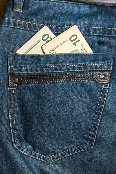 裤子口袋里的美元 免版税图库图片
