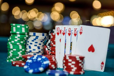 Royal flush combination with poker chips in casino