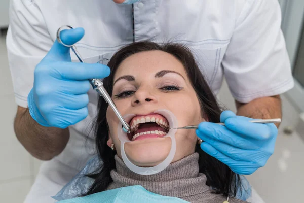 Doctor making treatment procedures in dentistry close up
