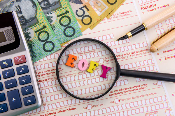 Magnifier with australian dollars and calculator on tax form