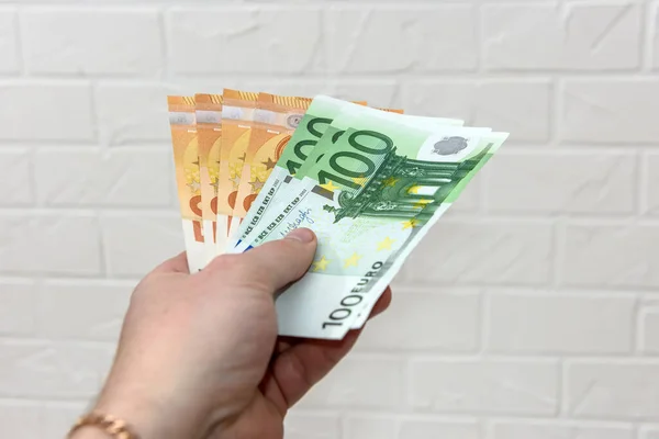 Human hand with euro banknotes close up