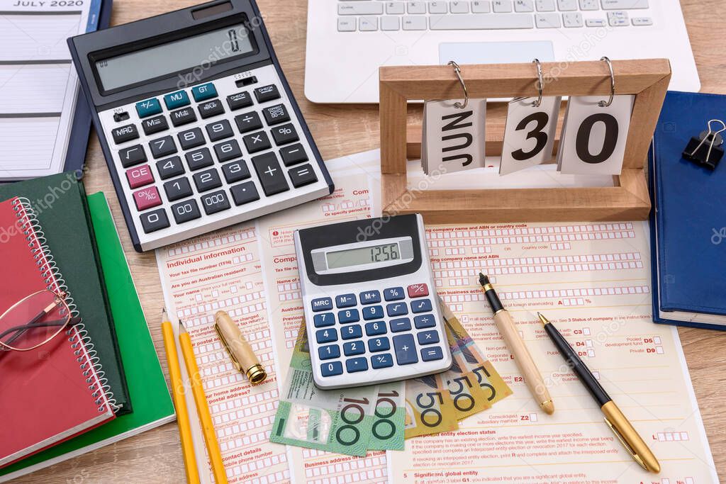 Wooden calendar with australian tax declaration on table