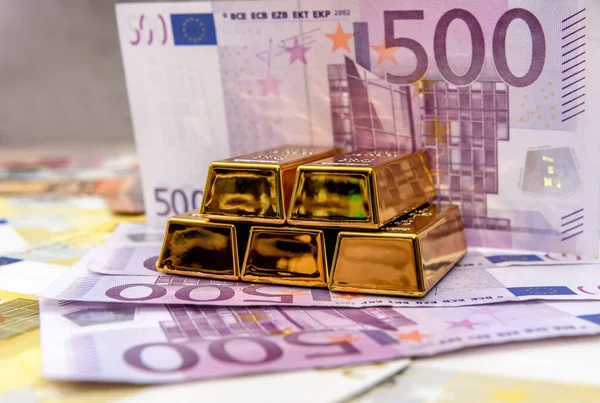 Pyramid of gold bullion on euro banknotes background