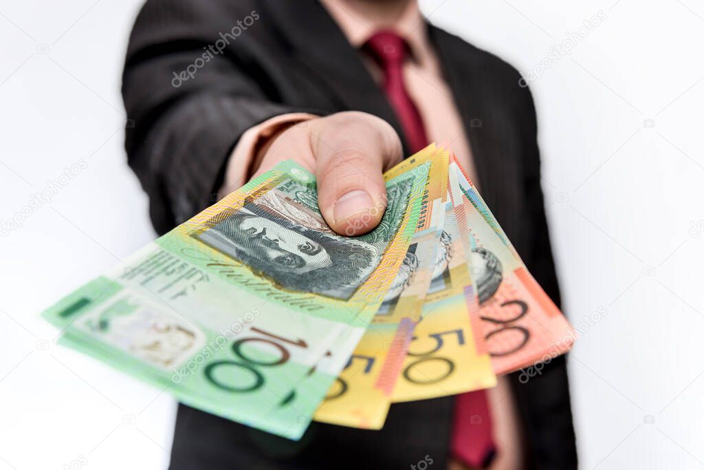 Man holding australian dollar banknotes close up