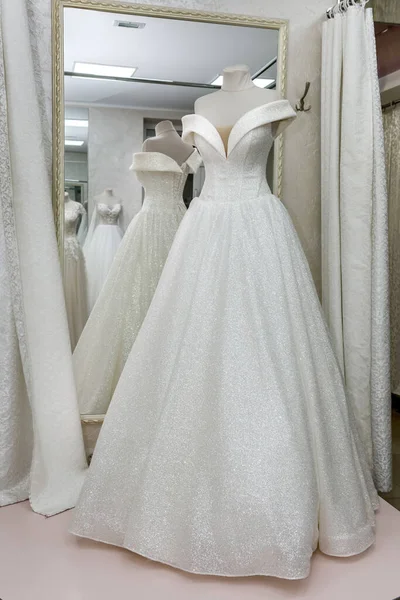 Beautiful wedding dress on a mannequin in salon