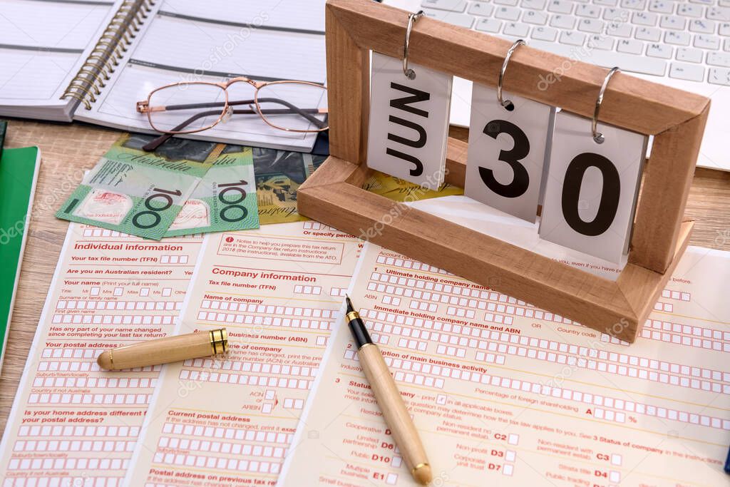 Wooden calendar with australian tax declaration on table