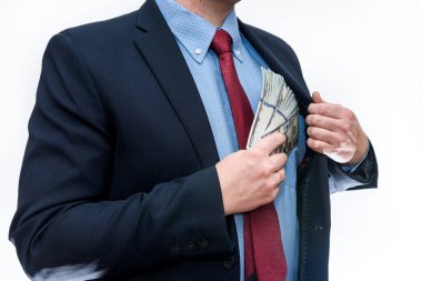 Takım elbiseli bir adam dolar banknotları tutuyor.