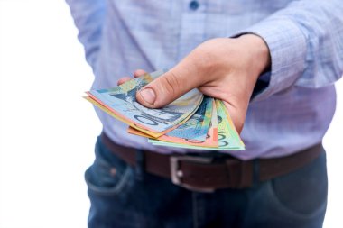 Erkek eller Avustralya doları banknotlarını sayıyor.