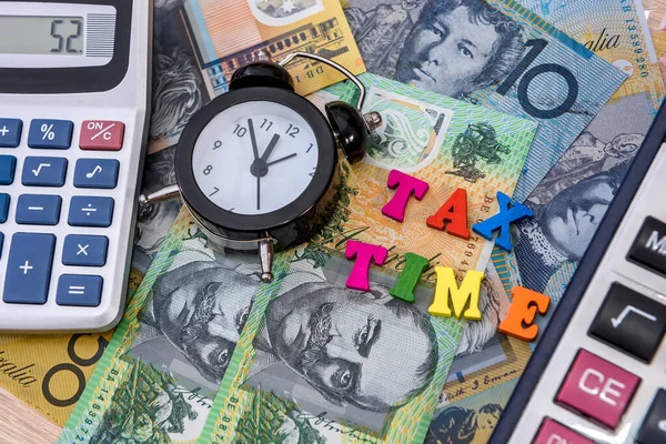 Australian dollars with clock and \'tax time\' text