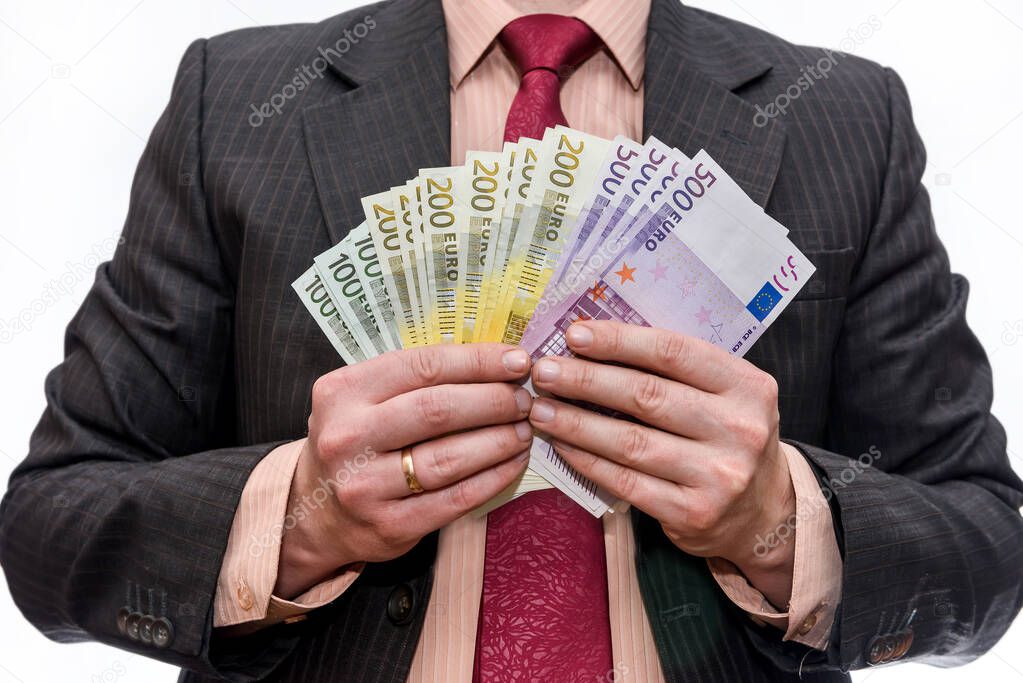 Businessman holding euro banknotes in fan isolated 