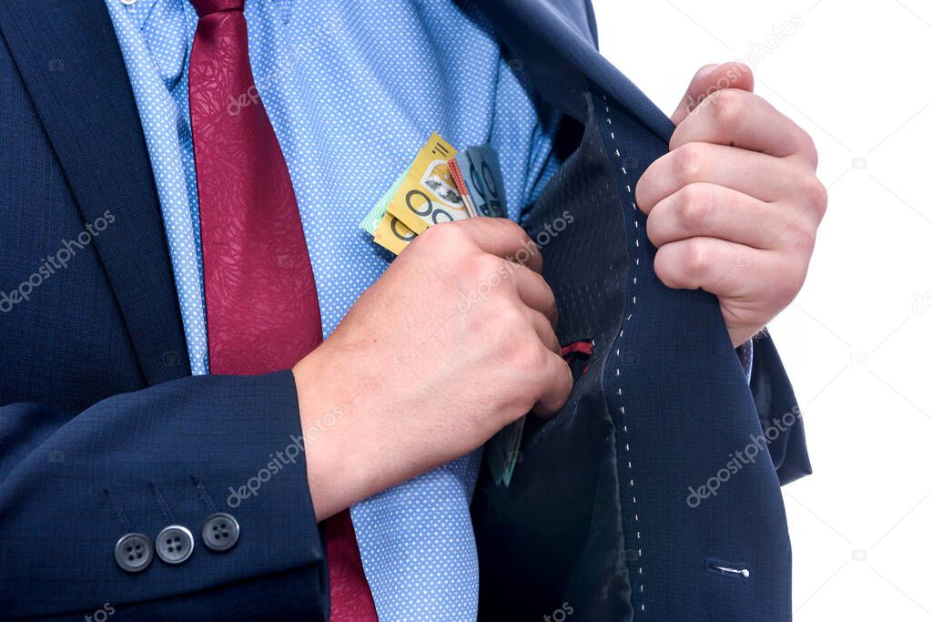 Man in suit holding australian dollar banknotes close up