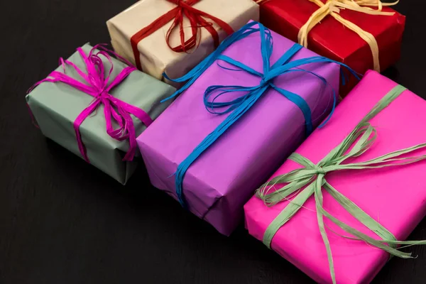 Colorful gift boxes on dark background. Celebration of new year and Christmas