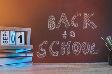School blackboard with text 'Back to school' . September and education concept