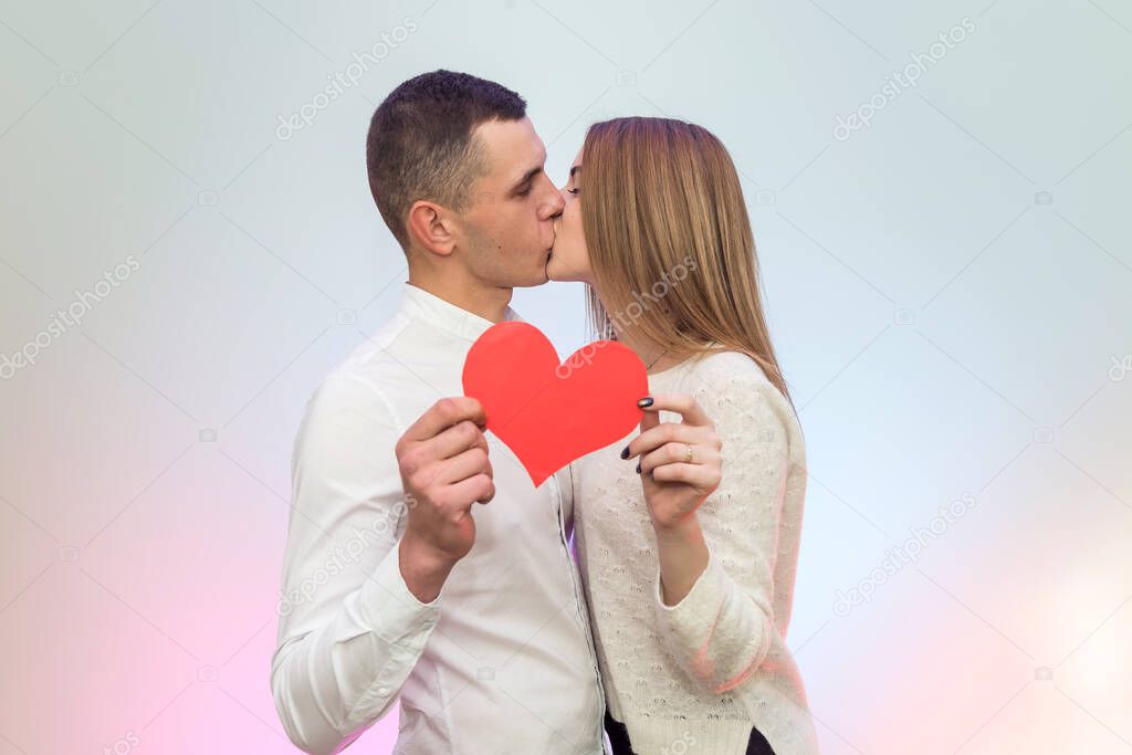 Couple in love holding red heart. Love and dating, celebration of St. Valentine's Day