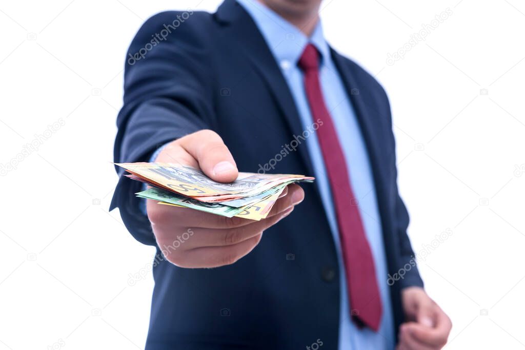 Man in suit offering australian dollar banknotes isolated on white