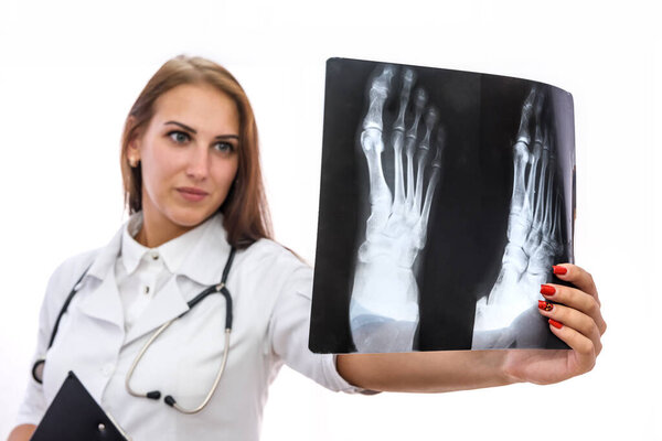 Doctor with x-ray isolated on white. Woman holding patient's x-ray and examining it