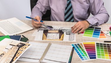 Mühendis ve mimar konsepti - Tasarımcı yaratıcı taslak planı planı ve renk örnekleyici ile çalışıyor