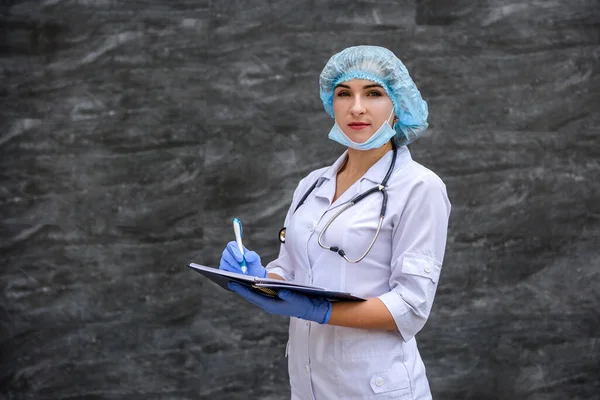 young nurse writes test results in a notebook. medical concept.