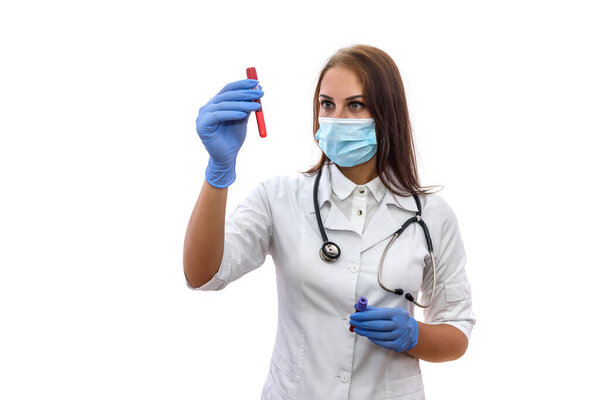 Doctor in mask examining test tubes with red substance isolated on white