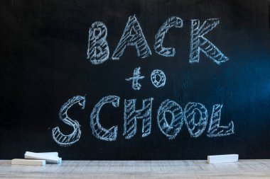 School blackboard with text 'Back to school' . September and education concept