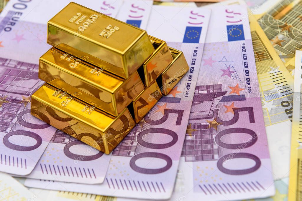 Pyramid of gold bullion on euro banknotes background