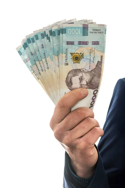 Kostümlü bir adam ve bir yığın Ukrayna parası. 1000 Hryvnia. UAH.