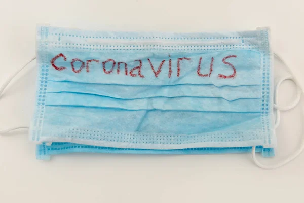 Medical disposable face mask with text covid-19. Coronavirus who causes pneumonia. Worldwide quarantine. disease