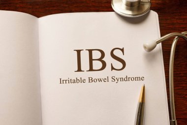 Page with IBS Irritable Bowel Syndrome on the table with stethoscope, medical concept clipart