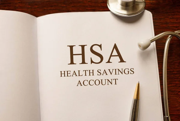 Page with HSA Health Savings Account on the table with stethoscope, medical concept