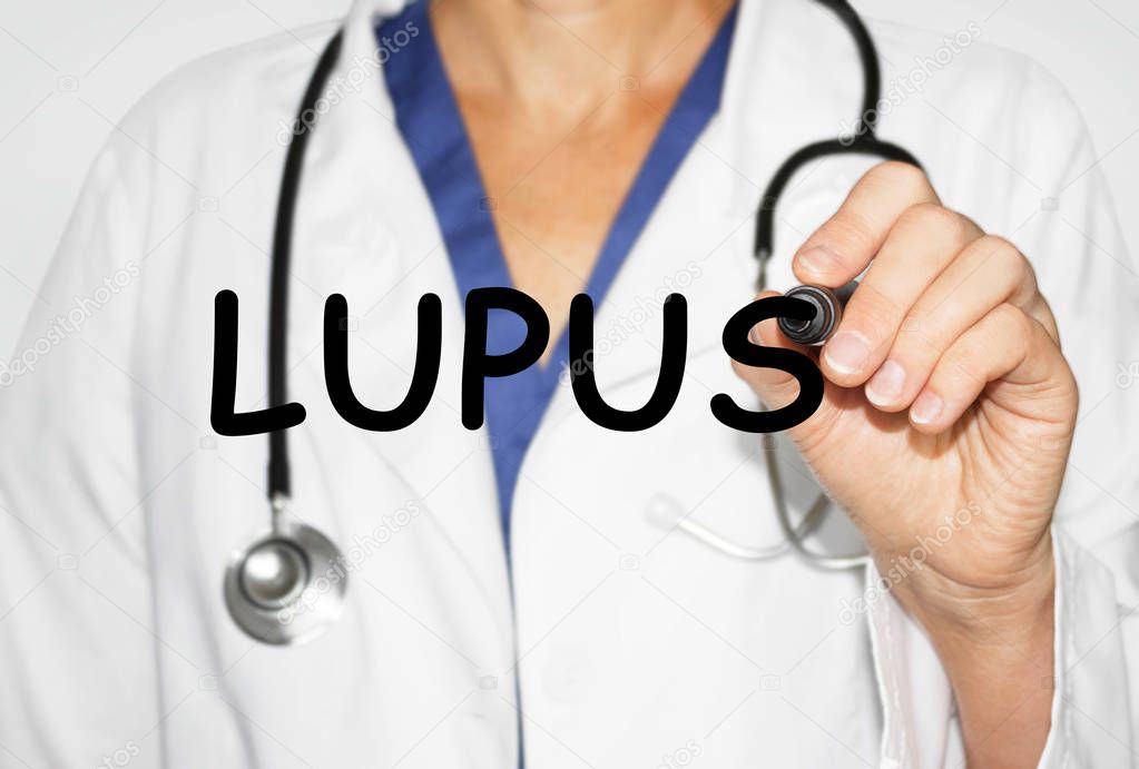 Doctor writing word Lupus, Medical concept