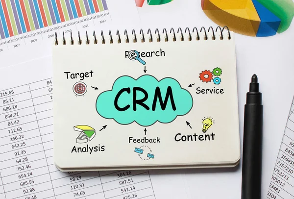 Notebook com ferramentas e notas sobre CRM, conceito — Fotografia de Stock
