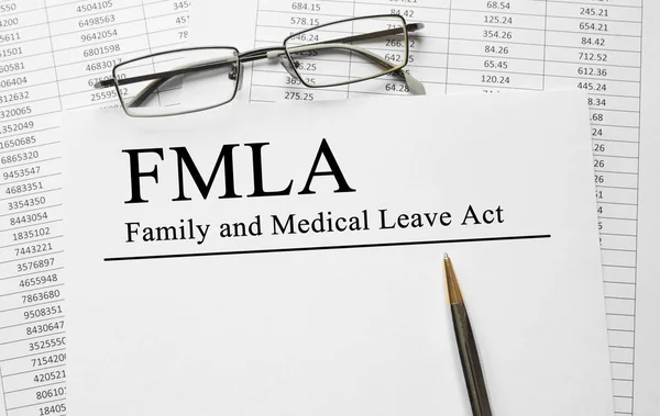 Paper with Family Medical Leave Act FMLA on a table — Stock Photo, Image