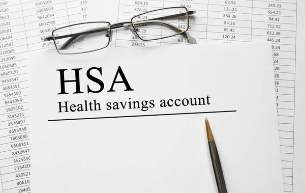 Paper with Health Savings Account HSA on a table