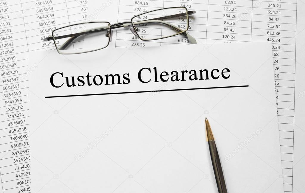 Paper with Customs Clearance on a table