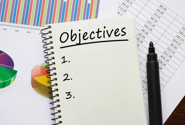 Cuaderno con herramientas y notas sobre los objetivos — Foto de Stock