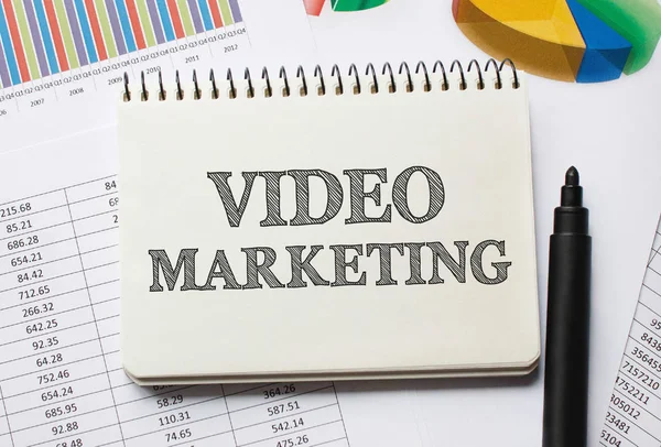 Notebook with Tools and Notes About Video Marketing