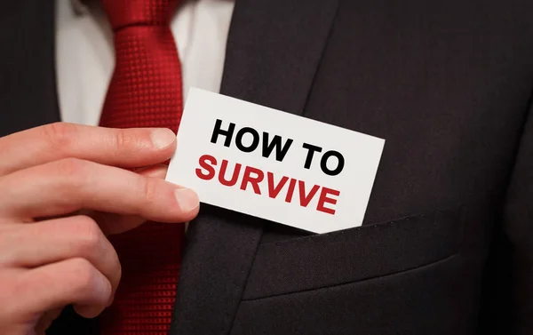 Businessman Putting Card Text How Survive Pocket — Stock Photo, Image