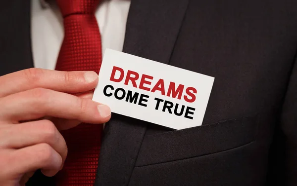 Biznesmen Wkłada Kieszeni Kartkę Tekstem Dreams Come True — Zdjęcie stockowe