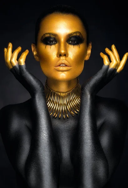 Woman in gold and black colors — Stock Photo, Image