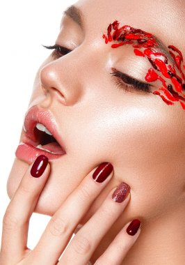 Genç bir kadın yüzüne dokunuyor