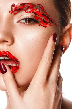 Genç bir kadın yüzüne dokunuyor