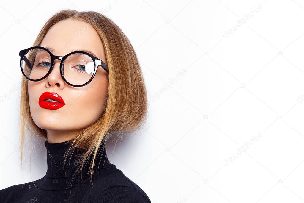 Portrait of young woman with red lips and eyeglasses posing on white background