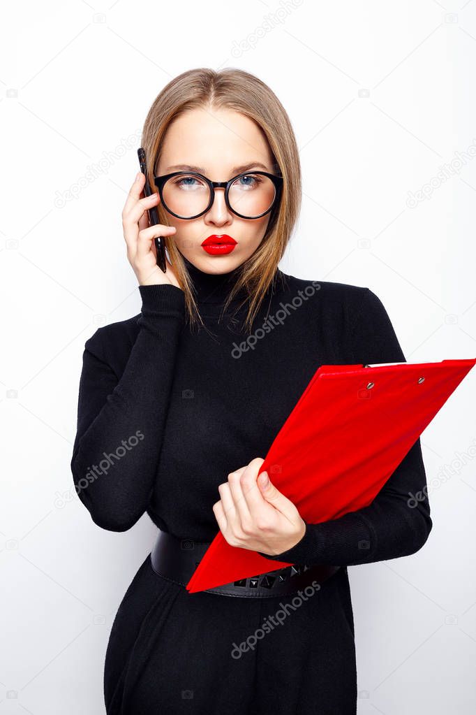 Stylish woman in black talking on smartphone against white background