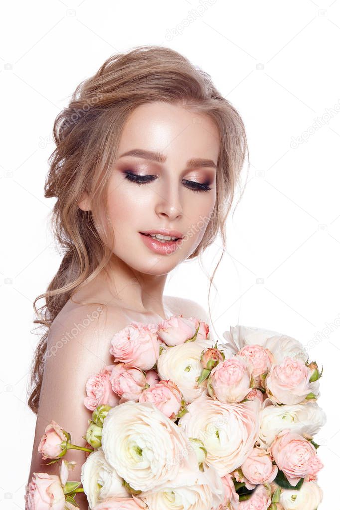 Young tender woman with bouquet of ranunculus and peonies on white background