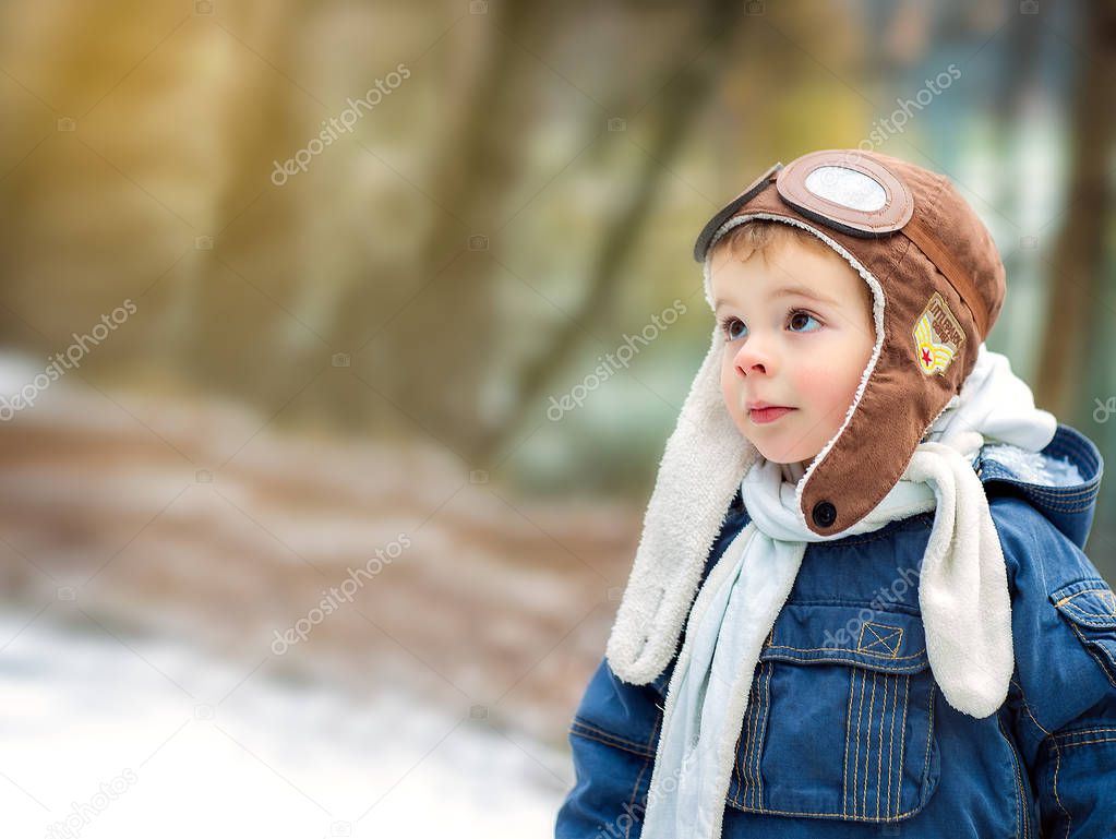 Portrait of young boy in pilot hat outdoor