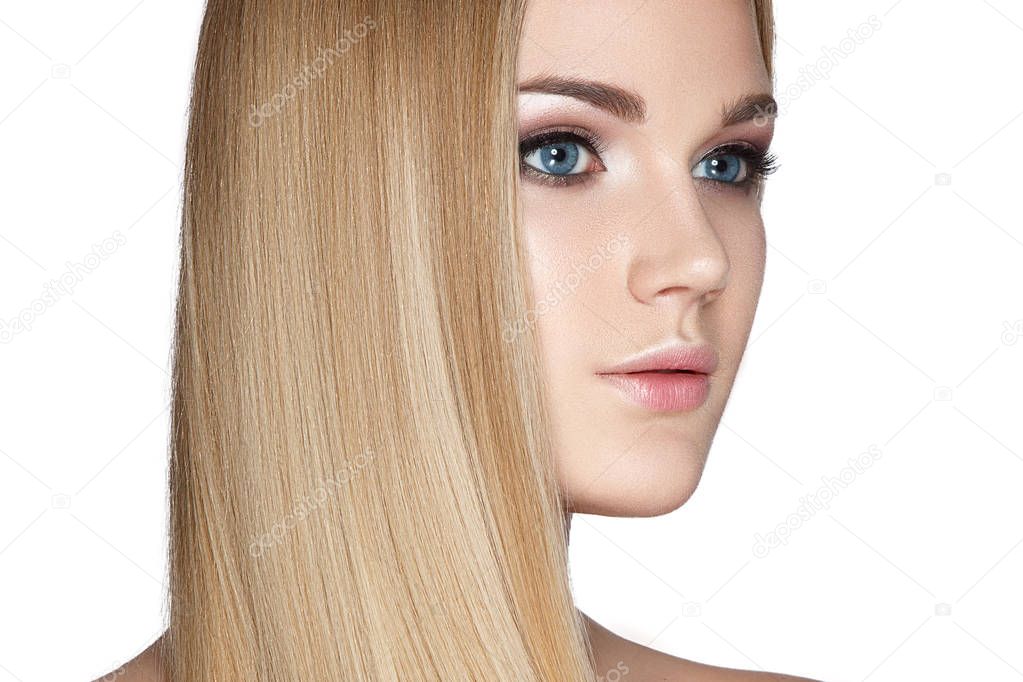 Portrait of blonde model with smooth long hair on white background