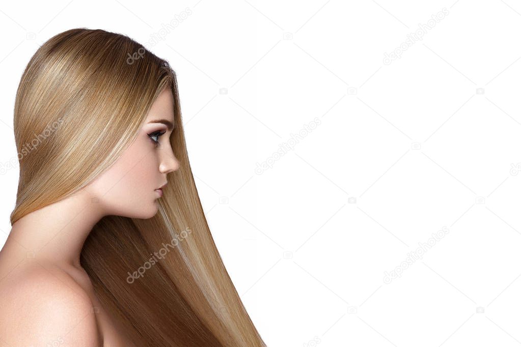Side view of young model with long blonde hair on white background